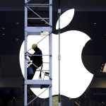 A worker climbs outside an Apple store in Hong Kong, in this April 10, 2013 file photo. China's "Great Firewall" may have been partly to blame for the first major attack on Apple Inc's App Store, but experts also point the finger at lax security procedures of some big-name Chinese tech firms and how Apple itself supports developers in its second biggest market. A malicious program, dubbed XcodeGhost, hit hundreds - possibly thousands - of Apple iOS apps, including products from some of China's most successful tech companies used by hundreds of millions of people. To match story APPLE-CHINA/CYBERSECURITY REUTERS/Bobby Yip/Files