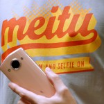 A model poses with a Meitu smartphone during Meitu IPO news conference in Hong Kong