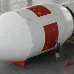 A labourer cleans the model of a Chinese Long March 2E rocket at a space exhibition in Wuhan, capital of central China's Hubei province, September 6, 2007. In 2003, China put a man in space, becoming only the third country to achieve the feat after the United States and the Soviet Union. It launched a second manned space flight last year, and plans a space walk by 2008. REUTERS/Stringer (CHINA) CHINA OUT
