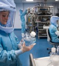 CORRECTION / Embargoed until March 30, 2021 - 22:01 GMT / Employees in cleanroom suits test the procedures for the manufacturing of the messenger RNA (mRNA) for the Covid-19 vaccine at the new manufacturing site of German company BioNTech on March 27, 2021 in Marburg, central Germany. - German firm BioNTech said on March 30, 2021 it was on track to manufacture 2.5 billion doses of its Covid-19 vaccine this year with US partner Pfizer, 25 percent more than previously expected. (Photo by Thomas Lohnes / AFP) / The erroneous mention[s] appearing in the metadata of this photo by Thomas Lohnes has been modified in AFP systems in the following manner: [---] instead of [---]. Please immediately remove the erroneous mention[s] from all your online services and delete it (them) from your servers. If you have been authorized by AFP to distribute it (them) to third parties, please ensure that the same actions are carried out by them. Failure to promptly comply with these instructions will entail liability on your part for any continued or post notification usage. Therefore we thank you very much for all your attention and prompt action. We are sorry for the inconvenience this notification may cause and remain at your disposal for any further information you may require.?