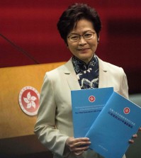 Hong Kong's Chief Executive Carrie Lam poses with copies of her first policy address as she arrives for a press conference at the Legislative Council in Hong Kong on October 11, 2017. 
Hong Kongers have a duty to stand up for China over threats to its sovereignty, the territory's leader Carrie Lam said on October 11, months after Beijing warned against any challenge to its control over the semi-autonomous city. / AFP PHOTO / Anthony WALLACE