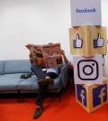 FILE PHOTO: A man reads a newspaper at the reception area of Facebook's new office in Mumbai
