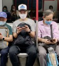 Passengers wear surgical masks in an MTR train in Hong Kong