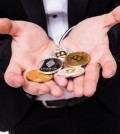 man holds different crypto coins in his hands isolated on white