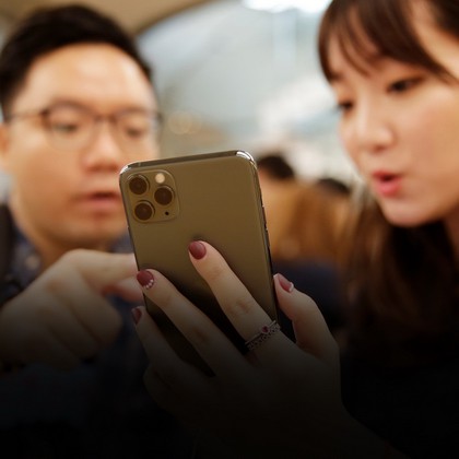 A customer touches an Apple's new iPhone 11 Pro Max after it went on sale at the Apple Store in Beijing, China, September 20, 2019. REUTERS/Jason Lee